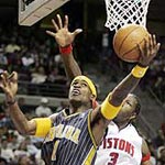 Person who phoned in bomb threat for Pacers locker room when they returned to the Palace. Indiana's Stephen Jackson slides under Detroit's Ben Wallace for a layup in the first quarter.