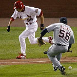 St Louis Cardinals So Taguchi runs on his sacrifice bunt as Detroit Tigers pitcher Fernando Rodney scrambles to pick up the ball in the seventh inning of Game 4 in Major League Baseball's World Series in St. Louis October 26, 2006. Rodney was charged with a throwing error on the play, which scored the Cardinals David Eckstein